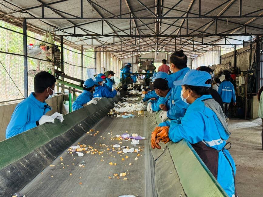 Workers sorting plastic material for recycling